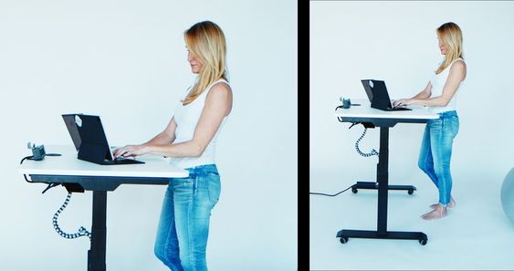 Woman at height adjustable desk from MojoDesk